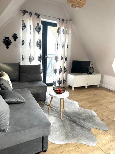 a living room with a couch and a table at Apart No15 Grapa in Białka Tatrzanska