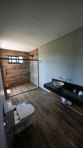a bathroom with a toilet and a sink at Vila Natur in Sao Jorge
