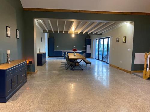a dining room with a table and chairs in a room at Moig Lodge - 8 Double Bedroom Barn Conversion in Limerick