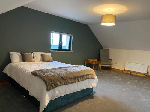a bedroom with a large bed in a room at Moig Lodge - 8 Double Bedroom Barn Conversion in Limerick