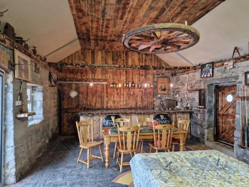 a dining room with wooden walls and a table and chairs at Moig Lodge - 8 Double Bedroom Barn Conversion in Limerick