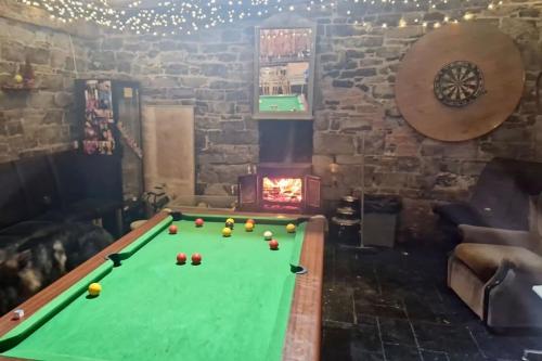 a pool table in a living room with a fireplace at Moig Lodge - 7 Double Bedroom Barn Conversion in Limerick