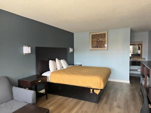 a hotel room with a bed and a couch at Red Carpet Inn & Suites - Danville in Danville