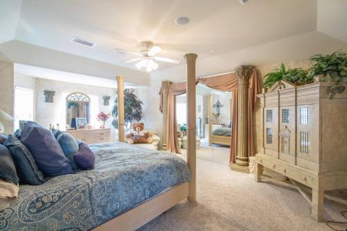a bedroom with a bed with a blue comforter at Central to everything in SA in San Antonio