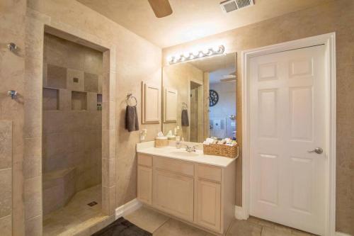 a bathroom with a sink and a shower and a mirror at Central to everything in SA in San Antonio