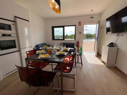 a kitchen and dining room with a table and chairs at Orange Grove Residence in Silves
