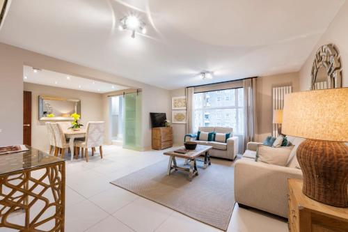 a living room with a couch and a table at CAMDEN Lux Apartment-Hosted by Sweetstay in London