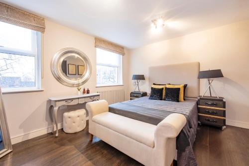 a bedroom with a bed and a mirror at CAMDEN Lux Suite-Hosted by Sweetstay in London