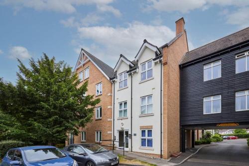 a group of buildings with cars parked in front of them at Modern Comfort 2BR Apartment - FREE Parking - FAST Internet in Oadby