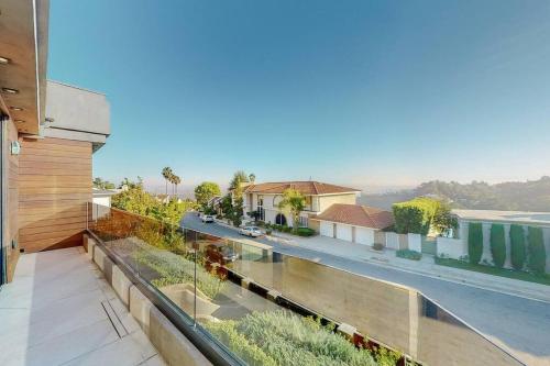 a house with a balcony with a view of a street at Luxurious Modern Mansion Hollywood Hills in Los Angeles