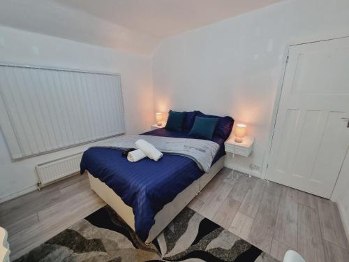 a bedroom with a bed with two pillows on it at Modern 3 bedroom house, 3 Bathroom, secure parking, Wi-Fi & Garden in Leeds