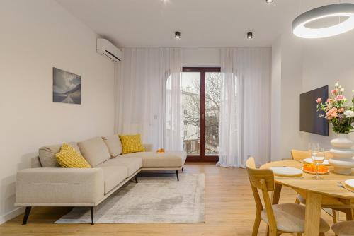 a living room with a couch and a table at P&O Apartments Sułkowicka - Mokotów in Warsaw