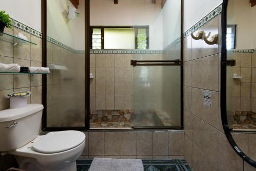 a bathroom with a toilet and a shower at HeCo House in Monteverde Costa Rica