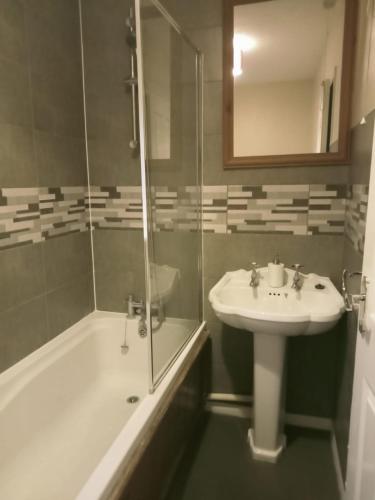 a bathroom with a sink and a shower and a sink at Kempston Cosy Lodge in Bedford