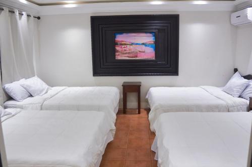 Un pat sau paturi într-o cameră la Hotel Villa Antigua