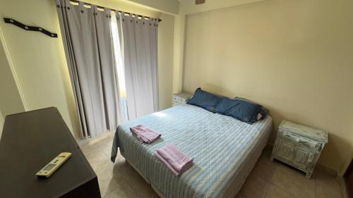 a small bedroom with a bed and a window at Cómodo Depto en Salta Capital, Argentina in Salta