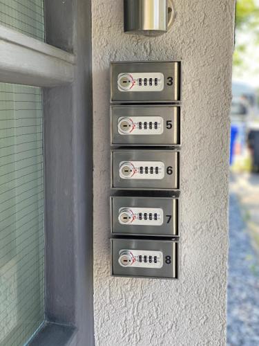 a wall with four signs on the side of a building at Designer-Apartment near Düsseldorf+Cologne (Apt.3) in Neuss