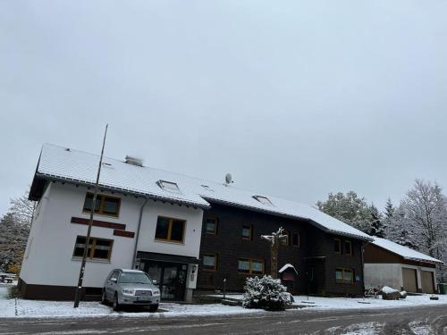 a building with a car parked in front of it at Naturfreundehaus Brend in Neuweg