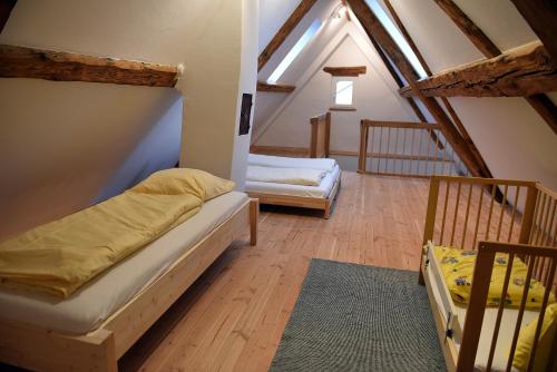 a attic room with two beds and a staircase at Ferienwohnung "Zur Krone" - zentrale Lage - NEU - in Zell im Wiesental