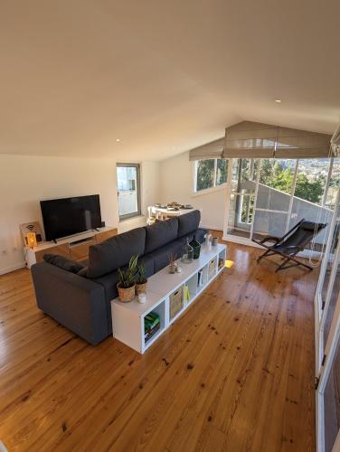 a living room with a couch and a tv at Cantinho dos Avós - Country House in Sever do Vouga