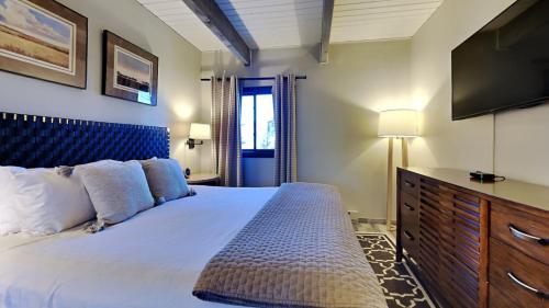a bedroom with a bed with a television and a dresser at Timberline Condominiums 1 Bedroom Premier Unit D2B in Snowmass Village