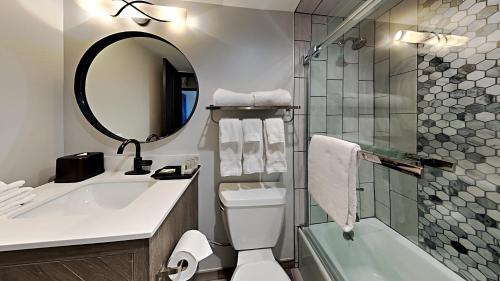 a bathroom with a sink and a toilet and a mirror at Timberline Condominiums 1 Bedroom Premier Unit D2B in Snowmass Village