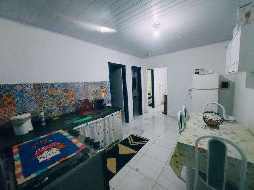 a kitchen with a table and a counter top at Lar, doce mar. in Paraty