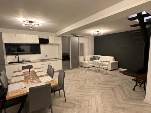 a kitchen and living room with a table and chairs at Vacation house in Borsa