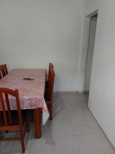 a table with chairs and a table cloth on it at Vacaciones Asequible in Necochea