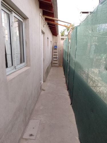 a hallway of a building with a fence and a ladder at Vacaciones Asequible in Necochea