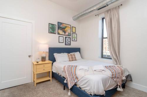 a bedroom with a blue bed and a window at McCormick Place 3Br/2Ba with Optional Parking in Chicago