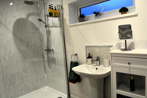 a bathroom with a shower and a sink at Family Retreat or Romantic Break 