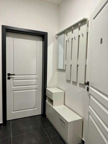 a bathroom with a closet with white cabinets and a door at Top class apartments in Carlsbad Bulharska street in Karlovy Vary