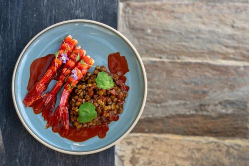 a plate of food with beans and vegetables on a table at Quinta do Tedo in Folgosa