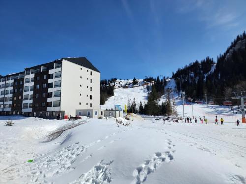 a building on top of a snow covered ski slope at Apartmani Sestosed-Snezna Dolina in Jahorina