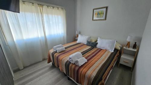 a bedroom with a large bed with towels on it at Hermoso departamento con cochera opcional in Buenos Aires