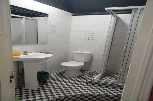 a bathroom with a toilet and a sink at Hostal Salvador in Santiago