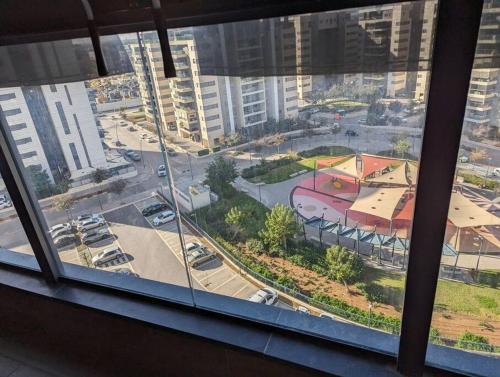 a view of a city from a window at Amazing Tower apt at karmei Gat- perfect familly vacation in Qiryat Gat