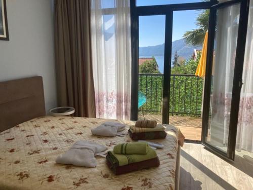 a bedroom with a bed with a view of a balcony at Apartments FANTASY in Kotor