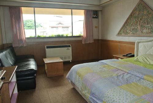 Ένα ή περισσότερα κρεβάτια σε δωμάτιο στο Anodard Hotel Chiang Mai