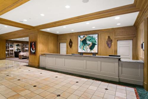 a large lobby with a counter in a building at The Royal Sonesta Harbor Court Baltimore in Baltimore