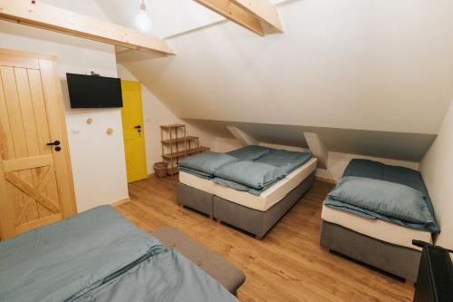 a room with two beds and a television in it at Nasza Chata in Duszniki Zdrój