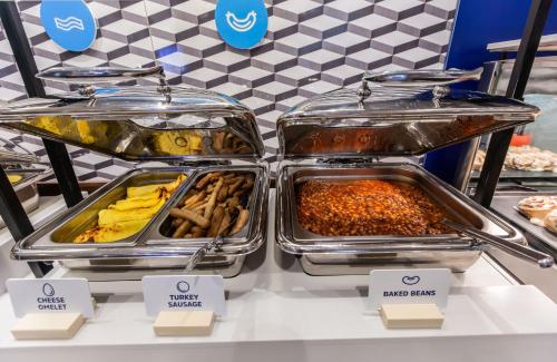 a buffet line with trays of food on display at Holiday Inn Express & Suites - Welland in Welland