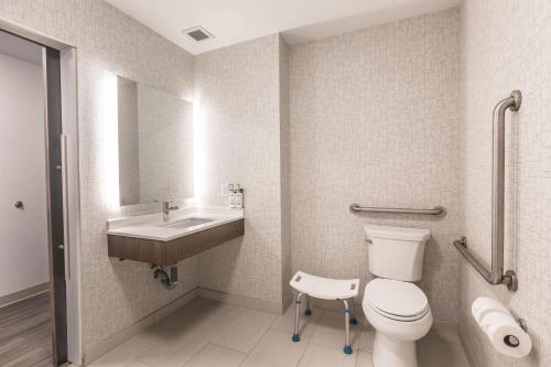 a bathroom with a toilet and a sink at Holiday Inn Express & Suites - Welland in Welland