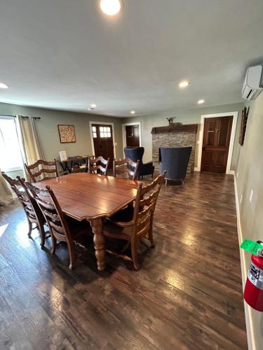 a dining room with a wooden table and chairs at The Rellik House in Central Point
