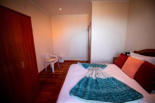 a bedroom with a bed with a dress on it at Casa da Montanha in Salão