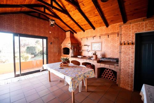 a large kitchen with a table and an oven at Casa da Montanha in Salão