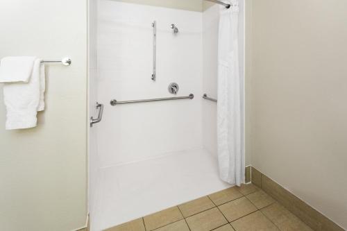 a bathroom with a shower and a toilet at Holiday Inn Express - New Albany in New Albany