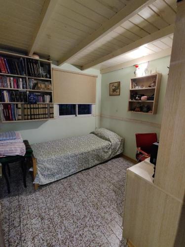 a bedroom with a bed and a book shelf at Your Place in Florida