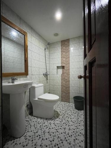 a bathroom with a toilet and a sink at Marian's Transient House in Puerto Princesa City